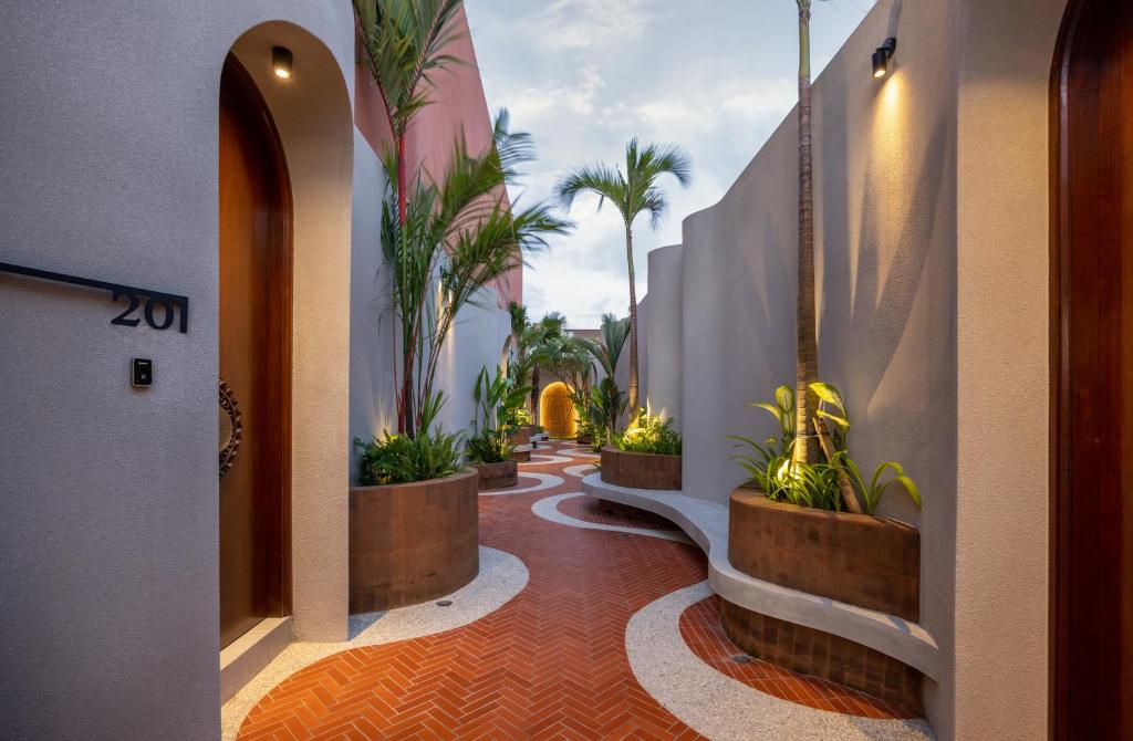 a hallway with potted plants in a building at Terra Villas Canggu in Canggu