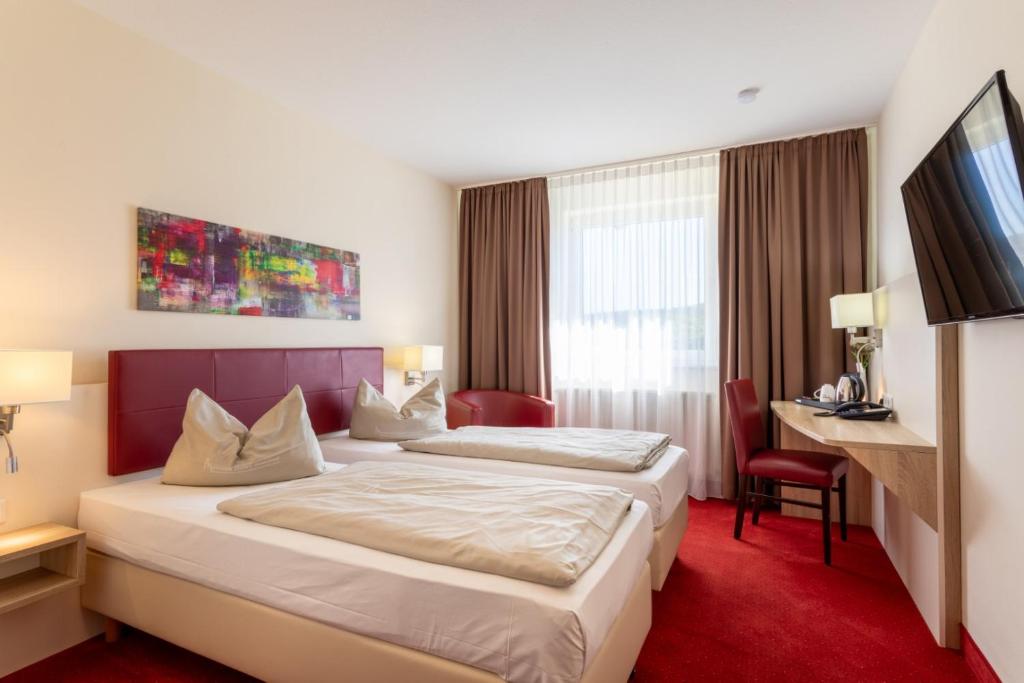 Postel nebo postele na pokoji v ubytování Hotel Montana