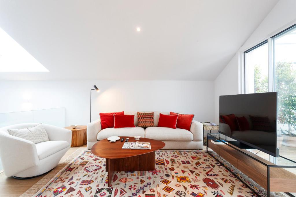 a living room with a white couch and a coffee table at Cascais Center Luxury Triplex in Cascais