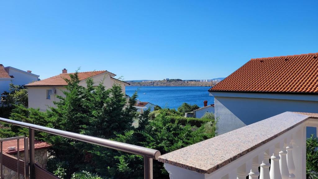 a view of the water from the balcony of a house at Apartments Adriana in Omišalj