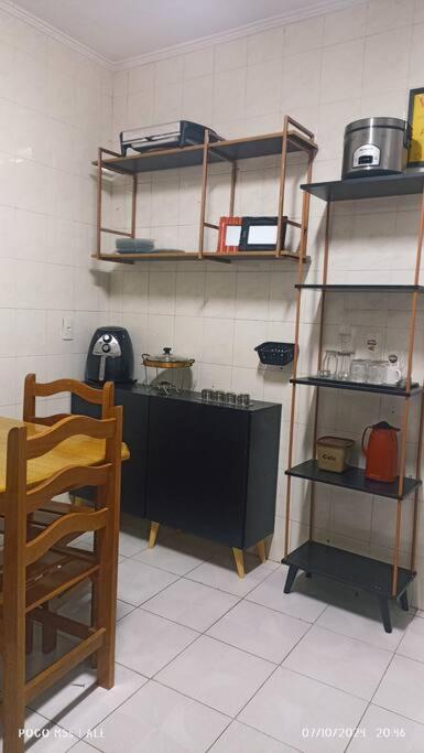a kitchen with a counter and shelves in a room at CASA sobrado edícula aconchegante in São Paulo