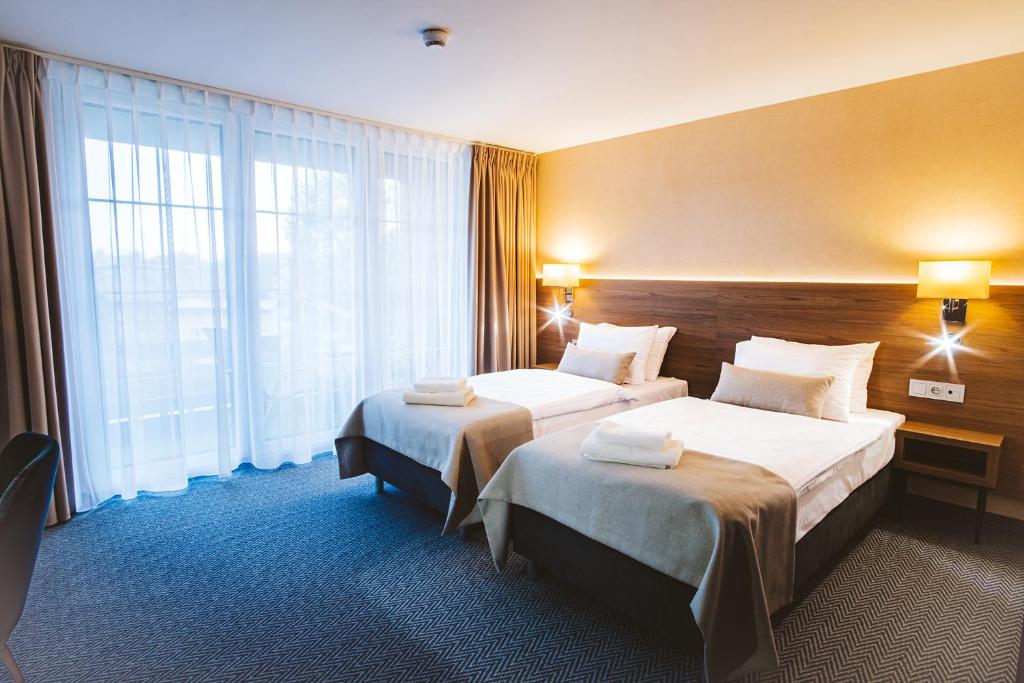 Postel nebo postele na pokoji v ubytování Hotel Piotr Spa&Wellness