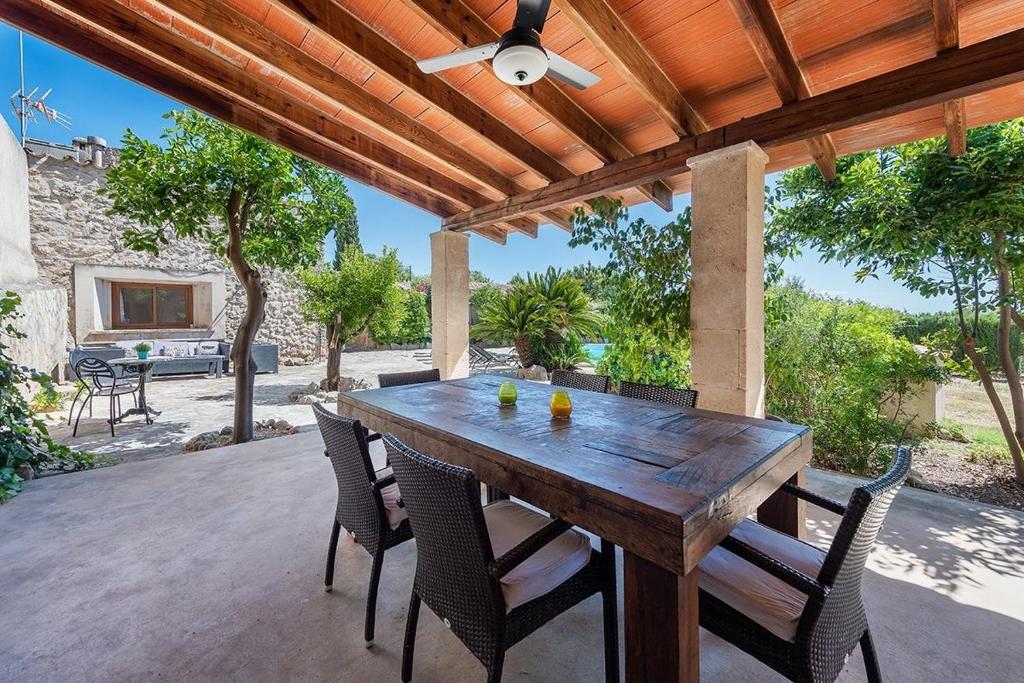 a wooden table and chairs on a patio at Villa - Sun and Moutain, Sa Murtera in Campanet
