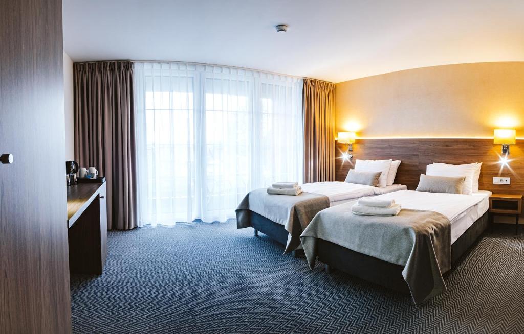 Postel nebo postele na pokoji v ubytování Hotel Piotr Spa&Wellness