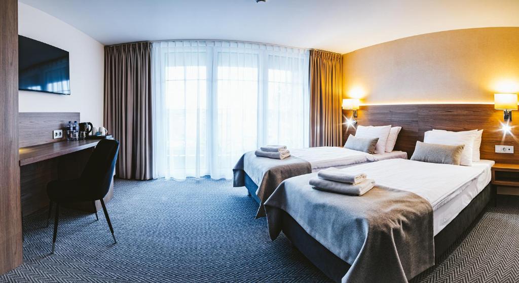 Postel nebo postele na pokoji v ubytování Hotel Piotr Spa&Wellness