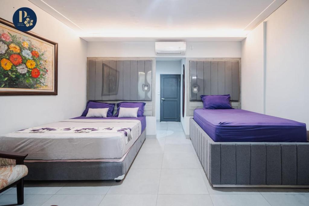 Postel nebo postele na pokoji v ubytování Bali Puspa Guest House