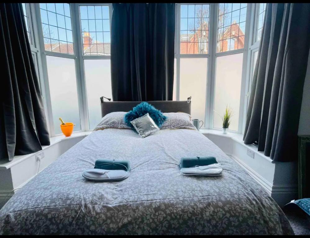 a bedroom with a bed with two towels on it at 1st 4 Tennants in Portsmouth