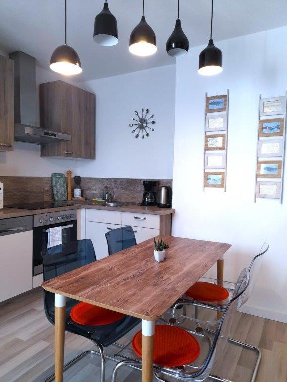 a kitchen with a wooden table and chairs at Ferienwohnungen Halbturn in Halbturn