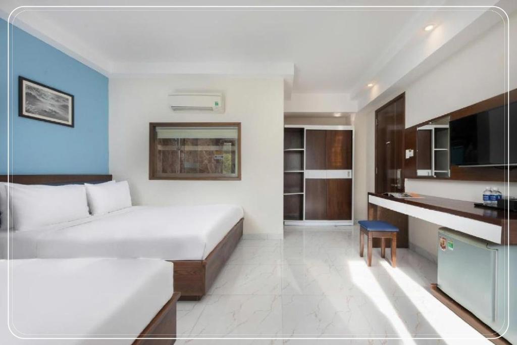 Postel nebo postele na pokoji v ubytování Ngoc Bich hotel