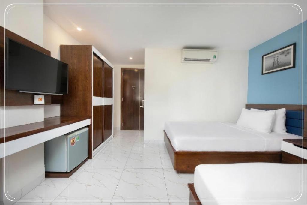 Postel nebo postele na pokoji v ubytování Ngoc Bich hotel