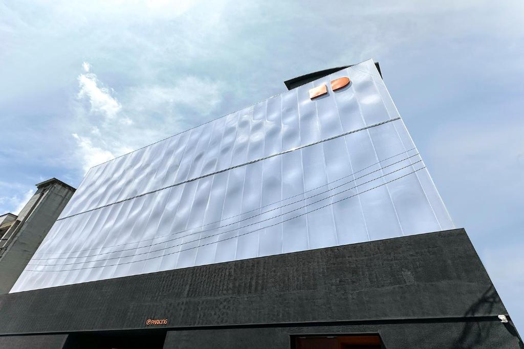 a tall glass facade of a building at Hotel RUGO in Jeonju