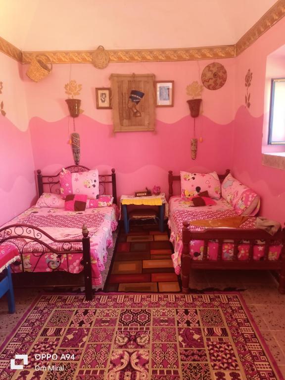 Postel nebo postele na pokoji v ubytování Miral Nubian House