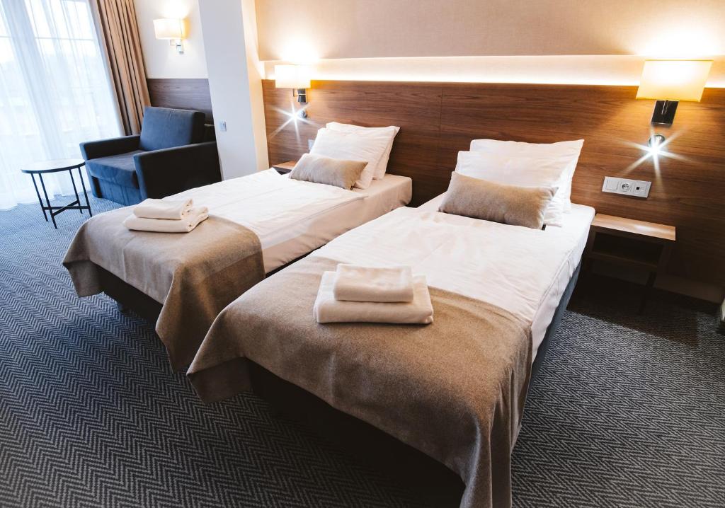 Postel nebo postele na pokoji v ubytování Hotel Piotr Spa&Wellness