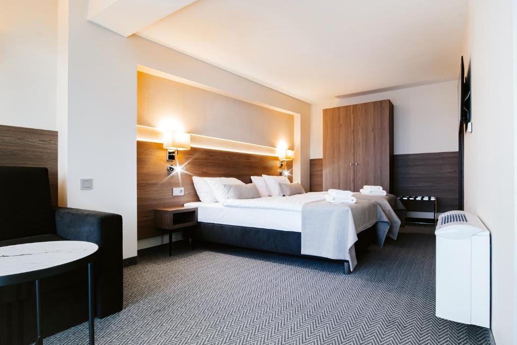 Postel nebo postele na pokoji v ubytování Hotel Piotr Spa&Wellness