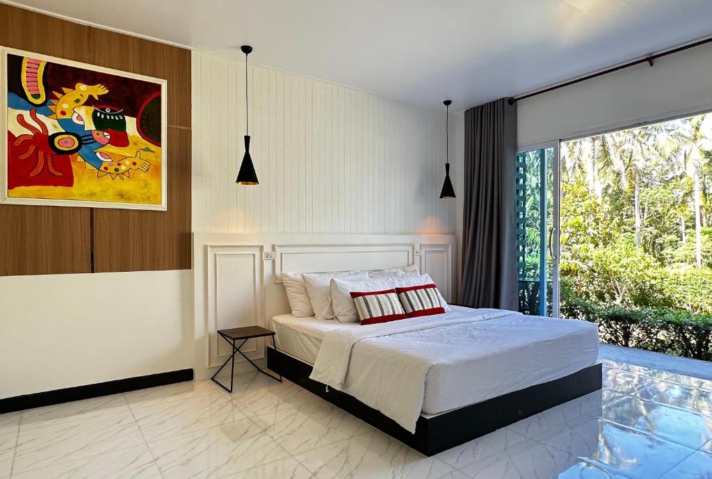 a bedroom with a bed and a large window at Koh Kood BED's in Ko Kood