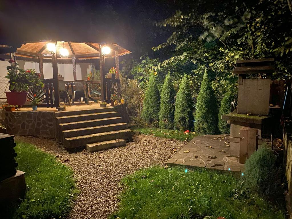 a garden at night with a gazebo at Chez Marcel Sinaia in Sinaia