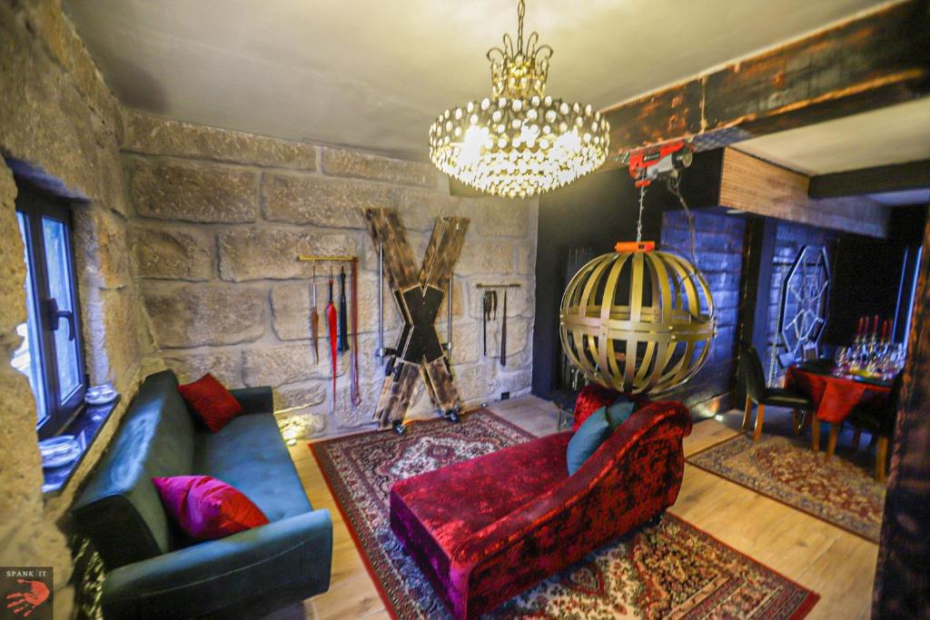 a living room with a couch and a chandelier at Spank IT in Tondela