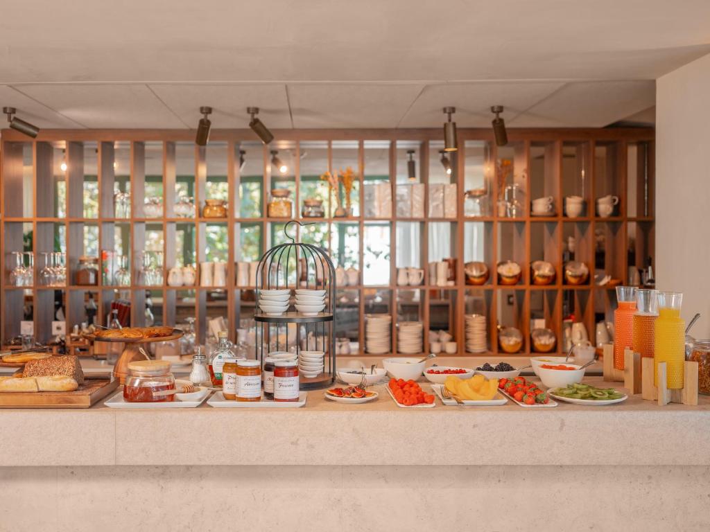 a buffet with many plates of food on a counter at Hôtel Liautaud Rooftop Cassis in Cassis