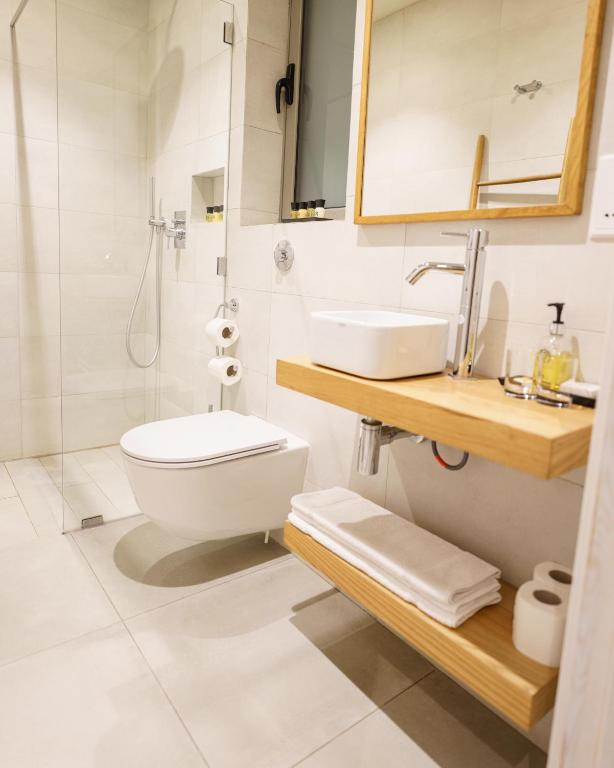 a bathroom with a toilet and a sink and a shower at Villa dei Venti in Qala