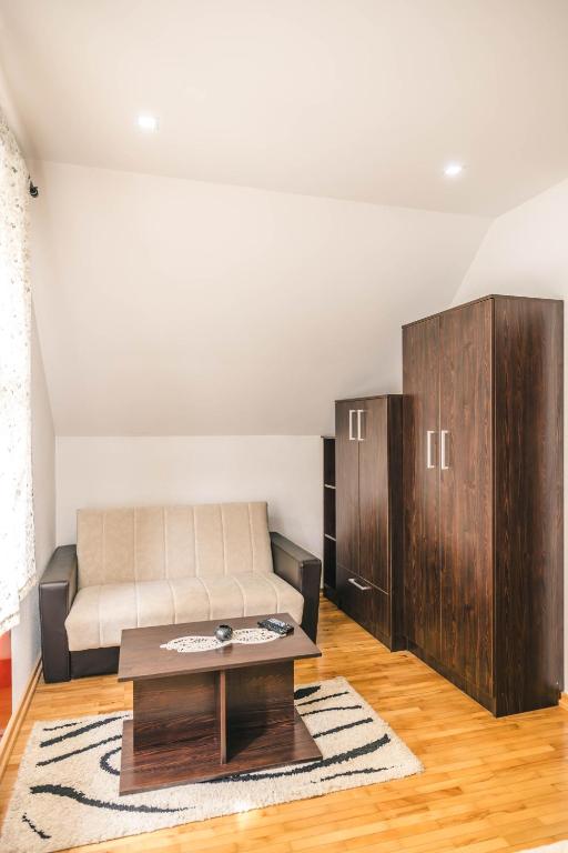 a living room with a couch and a coffee table at Lodge Zeleni svet in Crni Vrh