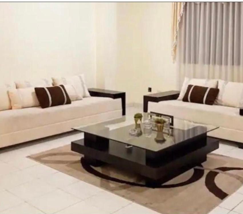 a living room with two couches and a coffee table at Amplio depto,parqueo,zona exclusiva in Cochabamba