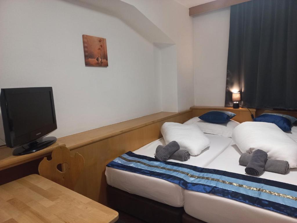 Postel nebo postele na pokoji v ubytování Hotel Untermetzger