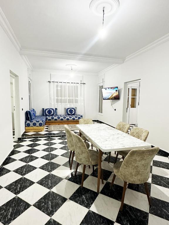 a dining room with a table and chairs at Ftouh House Heart of Tangier in Tangier