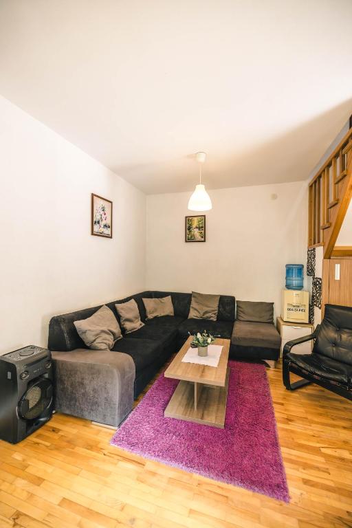 a living room with a couch and a table at Lodge Zeleni svet in Crni Vrh