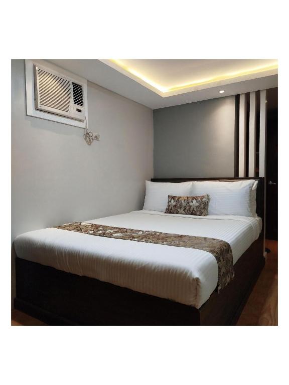 Postel nebo postele na pokoji v ubytování Buenaventura Suites