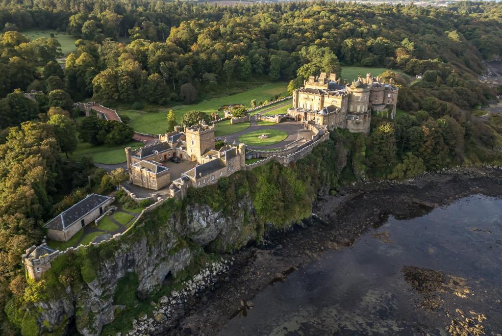 an aerial view of a castle on a cliff at Clocktower - Culzean Castle in Maybole