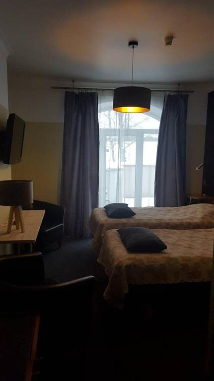 Voodi või voodid majutusasutuse Hotell De Tolly toas