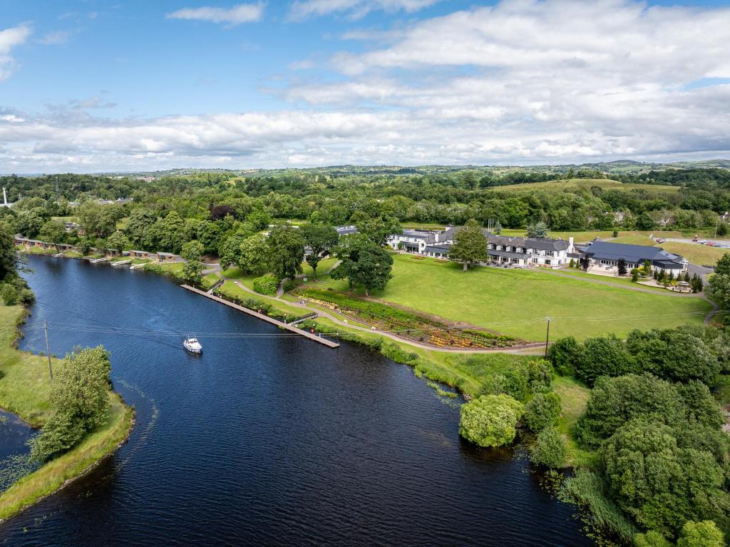 an aerial view of a river with a boat on it at Killyhevlin Lakeside Hotel & Lodges in Enniskillen