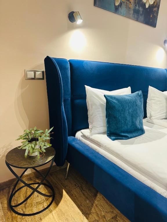 a blue couch in a room with a table at Style Residence in Sibiu