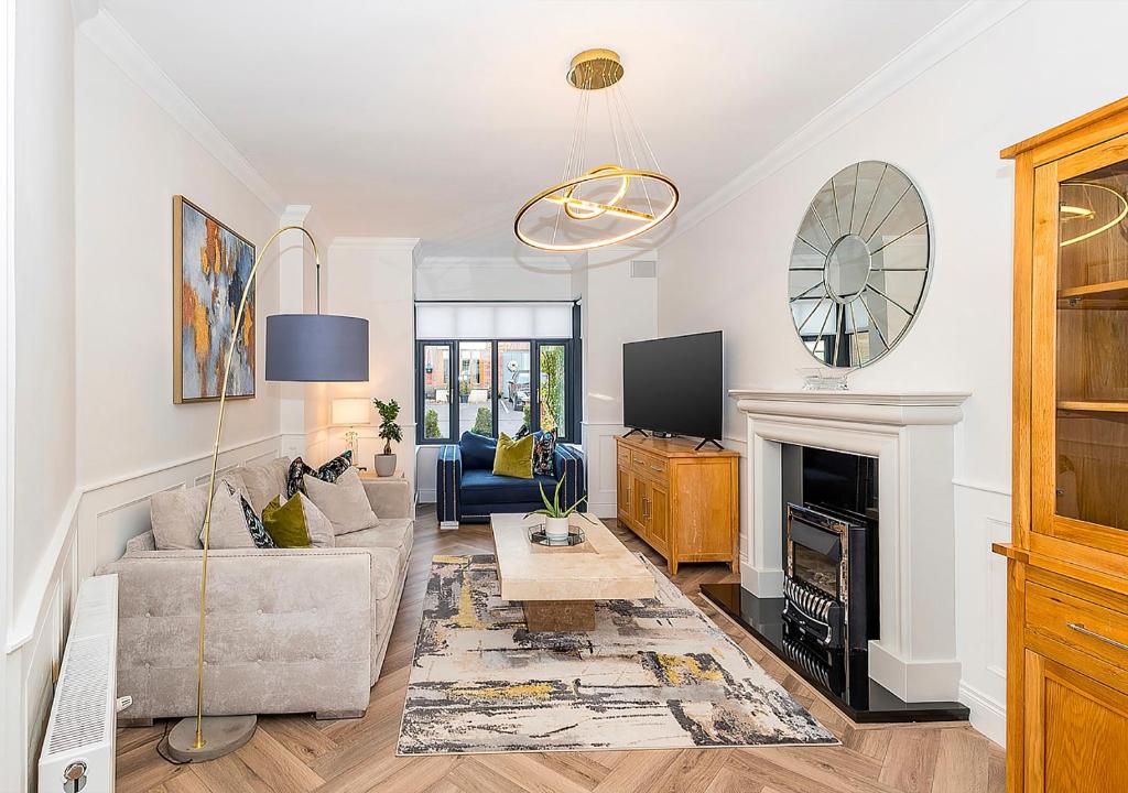 a living room with a couch and a fireplace at Malahide Castle Hideaway in Malahide
