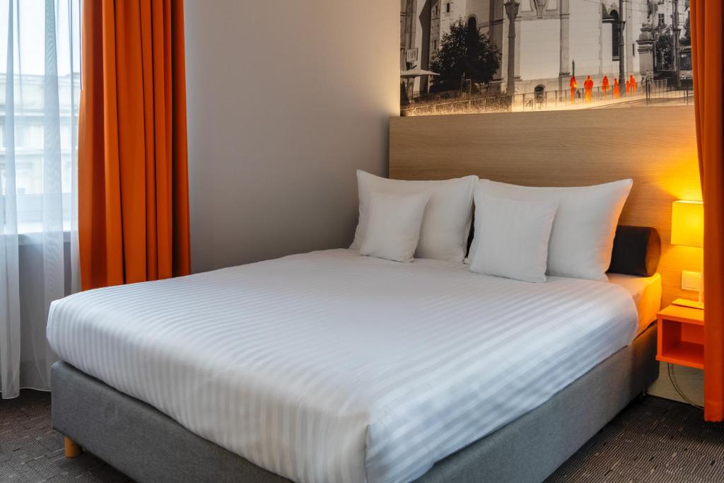 Postel nebo postele na pokoji v ubytování Hotel MDM City Centre