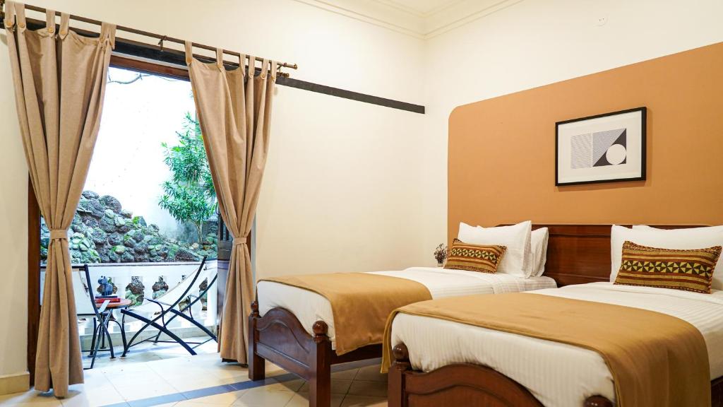 Postel nebo postele na pokoji v ubytování Olive Hotel Alidia Beach Resort by Embassy Group