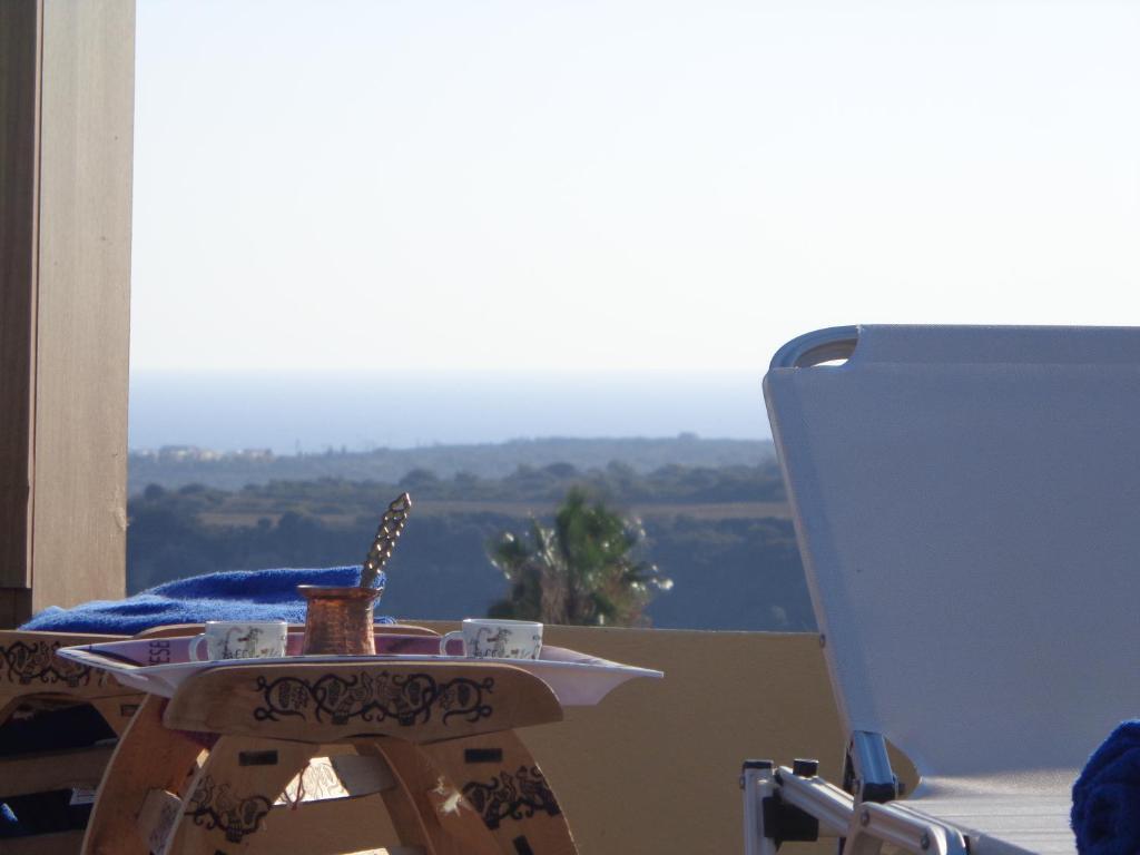 a table with a cup of coffee and a view at Villa Kiki in Lachania