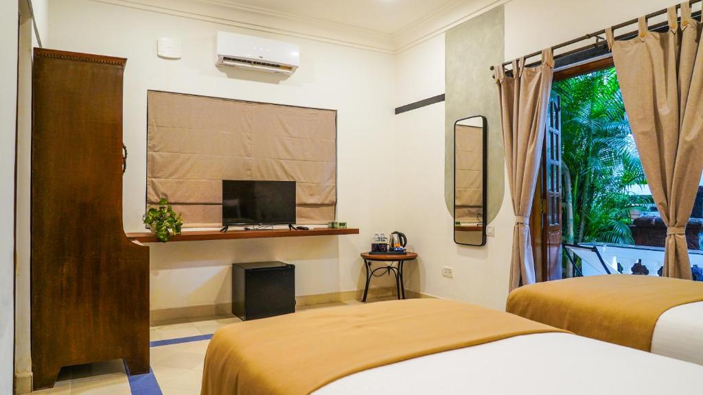 Postel nebo postele na pokoji v ubytování Olive Hotel Alidia Beach Resort by Embassy Group