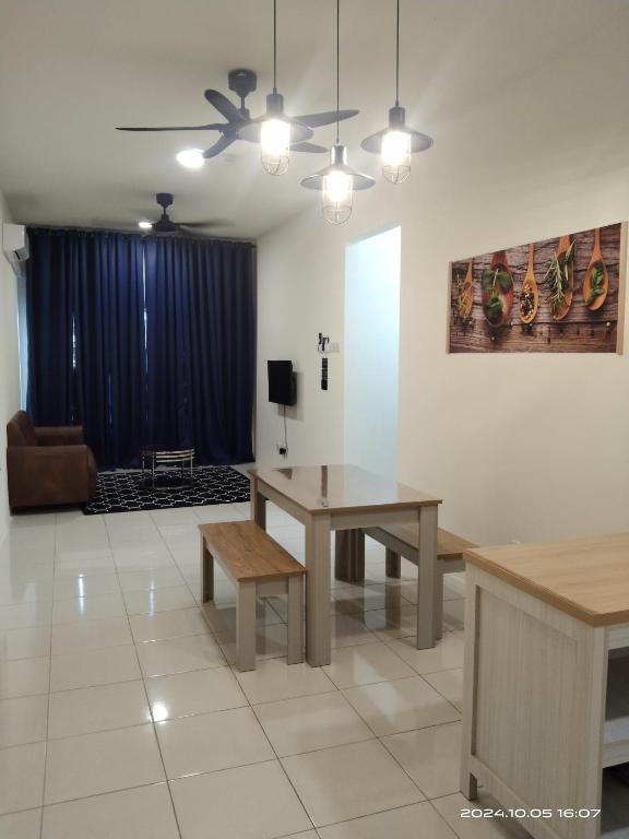 a living room with a table and a couch at Alam Indah Homestay in Bandar Puncak Alam