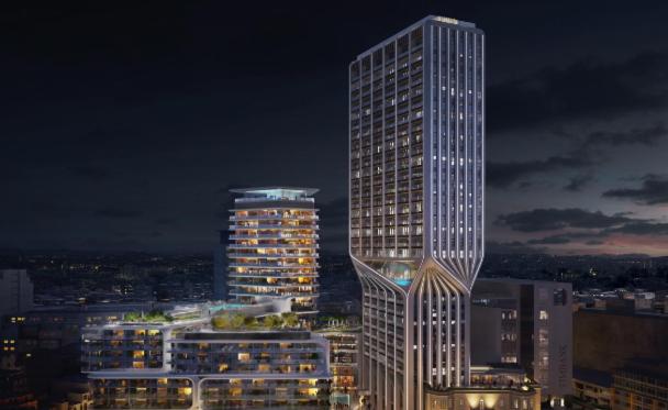 a tall skyscraper building in a city at night at The Signature Suite in Mercury Tower in St. Julianʼs
