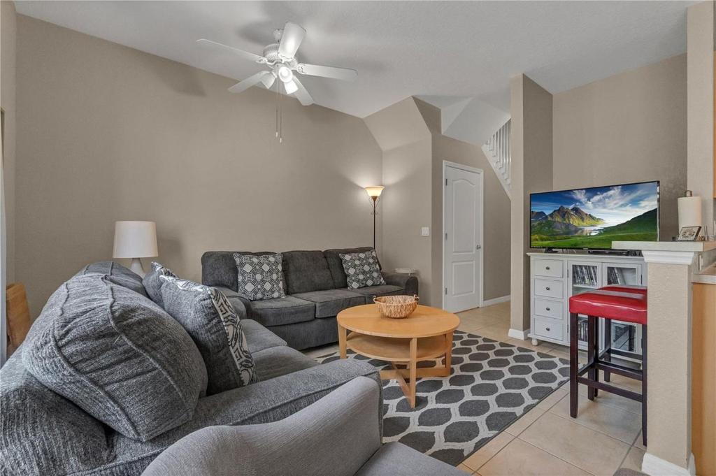 a living room with a couch and a table at Enjoy my cozy house next to Disney in Kissimmee