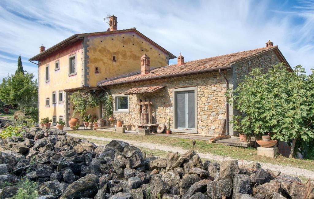 a stone house with a stone wall in front of it at Pet Friendly Home In Cortona With Wifi in Cortona