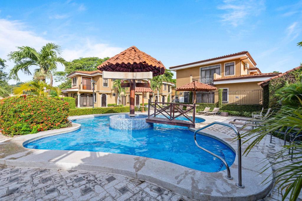 a house with a swimming pool in a yard at Villa with Pool, Gated Playas del Coco Getaway in Coco