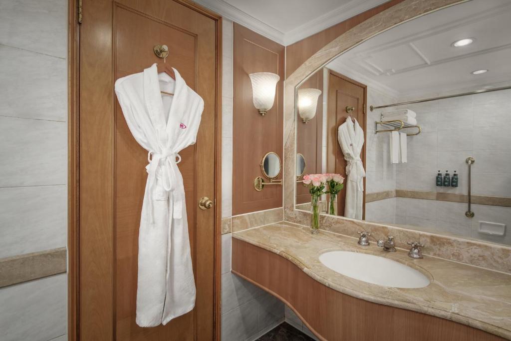 a bathroom with a sink and a white robe at Crowne Plaza Chengdu City Center by IHG in Chengdu