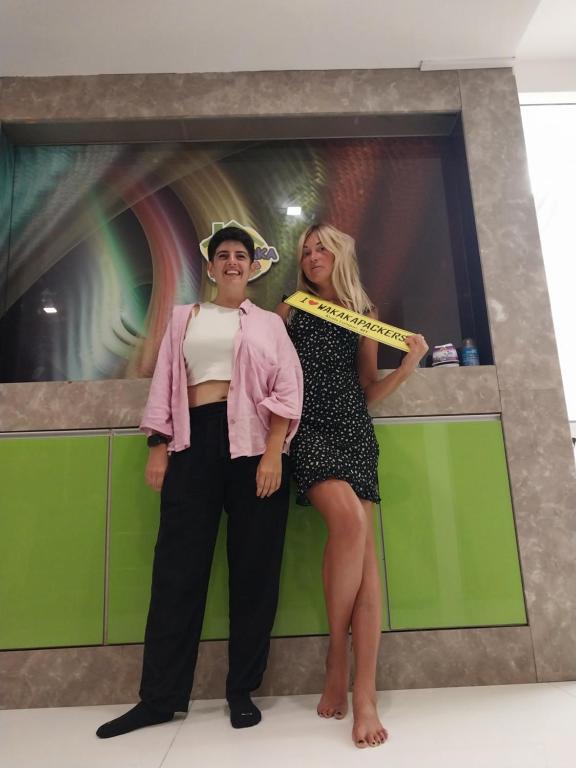 a man and a woman holding a ruler at WakakaPackers in Kuala Lumpur