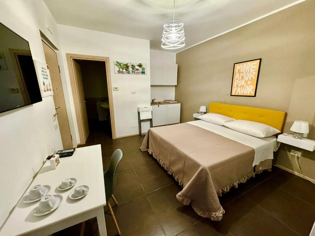 a hotel room with a bed and a table and a table sidx sidx at Cozy Studio in Salerno - 20 m² with Terrace in Salerno