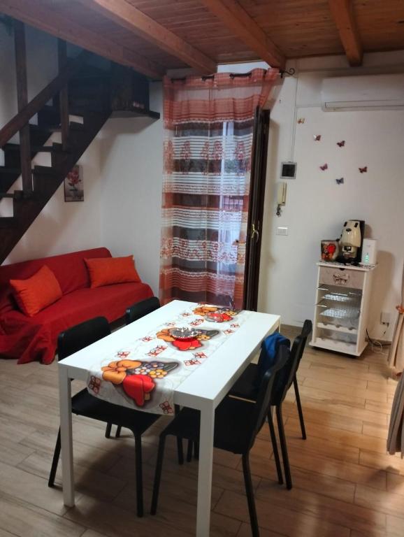a living room with a white table and chairs at MuSa Apartment in Catania