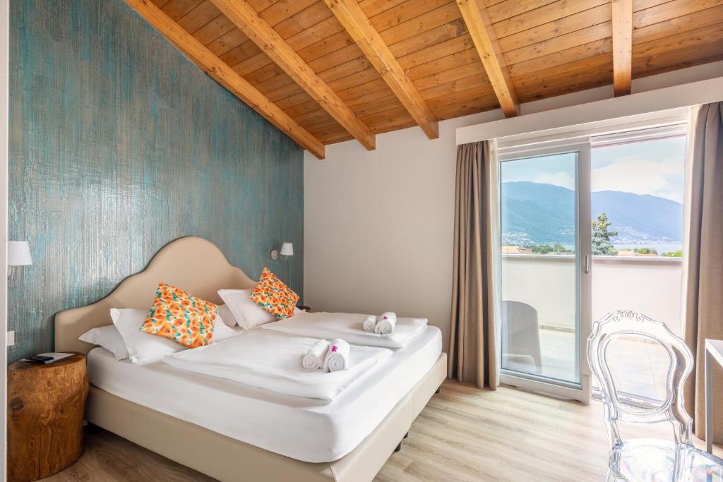 Postel nebo postele na pokoji v ubytování Hotel Elvezia