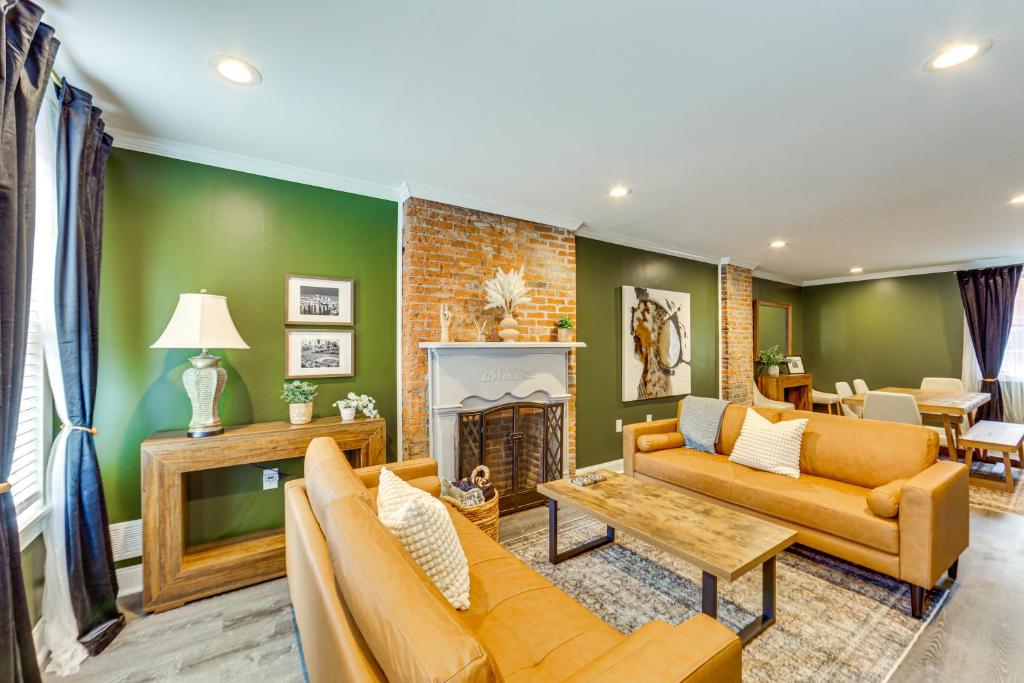 a living room with orange furniture and a fireplace at 1 Mi to Dtwn Walkable Gem in Pittsburgh in Pittsburgh
