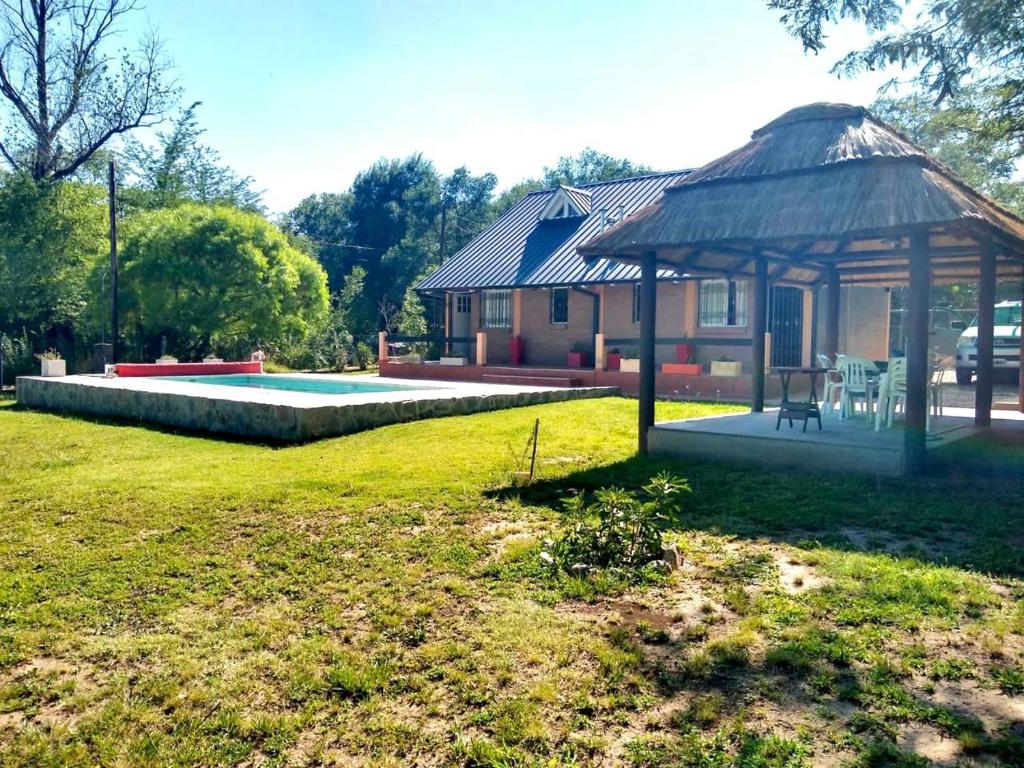 a house with a gazebo in a yard at Los Laureles de Sorso in Villa Ciudad Parque